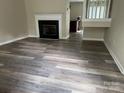 Spacious living room with hardwood flooring and a cozy fireplace, creating an inviting atmosphere at 1814 Birch Heights Ct, Charlotte, NC 28213