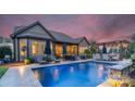 Stunning backyard with a sparkling pool, lounge chairs, and an outdoor dining area, perfect for entertaining at 2009 Freeport Dr, Indian Trail, NC 28079