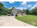 Spacious home featuring a side-entry garage, a fenced-in yard, and lush landscaping at 205 Honey Moss Ln, Salisbury, NC 28146