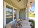 Cozy front porch with seating area, featuring comfortable chairs and a small table with decorative plants at 2301 Amesbury Ct, Albemarle, NC 28001