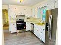 Efficient kitchen featuring sleek stainless steel appliances, bright white cabinets, and natural light at 2660 Tiffany St, Conover, NC 28613