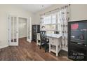 Bright office featuring wood floors, a window, and a modern desk at 404 Saddlebred Ln, Locust, NC 28097