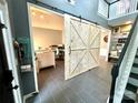 Bright office area with custom sliding barn door and view to 2nd floor landing at 4205 Springhaven Dr, Charlotte, NC 28269