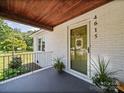 Close up of a quaint front porch with a painted ceiling and decorative potted plants at 4615 Lockhart Rd, Sharon, SC 29742