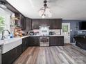 An updated kitchen features stainless steel appliances, an apron sink, and wooden cabinets at 4615 Lockhart Rd, Sharon, SC 29742