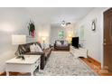 Bright living room with a ceiling fan, natural light, neutral walls, and a decorative rug on hardwood floors at 4919 Rehobeth Rd, Waxhaw, NC 28173