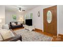 Cozy living room with hardwood floors, a ceiling fan, a decorative rug, and a view of the front door at 4919 Rehobeth Rd, Waxhaw, NC 28173