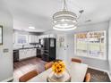 Bright eat-in kitchen features stainless appliances, wood floors, and a stylish chandelier at 5116 Crane Point Dr, Charlotte, NC 28227