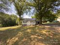 Charming home featuring a quaint porch, complemented by fresh, neutral siding, and a durable metal roof at 608 E 11Th St, Newton, NC 28658
