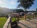 Spacious wooden deck offering serene waterfront views of the lake and surrounding landscape at 690 Lake Head Rd # 132, Norwood, NC 28128