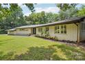 Beautiful ranch-style home with a well-maintained lawn and tasteful landscaping at 7107 Cedarfield Rd, Charlotte, NC 28227