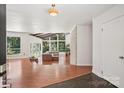 Open concept living room features hardwood floors, large windows, and natural light at 7107 Cedarfield Rd, Charlotte, NC 28227