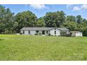 Sprawling front lawn of home surrounded by mature trees and manicured landscaping at 7109 Forney Hill Rd, Denver, NC 28037