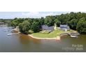 Aerial view of waterfront homes with docks and lush green lawns at 735 Pebble Pt, Salisbury, NC 28146