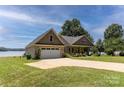 Brick home boasts an attached garage and a well-manicured lawn at 735 Pebble Pt, Salisbury, NC 28146