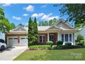 Attractive single-story brick home featuring lush landscaping and a convenient three-car garage at 8712 Soaring Eagle Ln, Waxhaw, NC 28173
