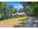 Beautiful brick home with landscaped front yard and long driveway at 107 Creekwood Dr, Dallas, NC 28034