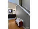 Hallway with hardwood floors, staircase, and a bench with access to the living room at 10825 Traders Ct, Davidson, NC 28036
