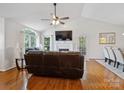 Inviting living room featuring hardwood floors, a fireplace, and large windows that flood the space with natural light at 132 General Pemberton St, Stanley, NC 28164