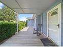Inviting front porch with a rocking chair and a view of the lush green lawn at 151 Robinson Rd, Gastonia, NC 28056