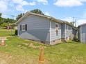 Rear view of the single-story home with a partial basement and exterior access at 151 Robinson Rd, Gastonia, NC 28056