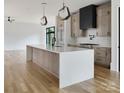 Bright kitchen with a large island, modern pendants, and stainless steel appliances at 1511 Waverly Ave, Charlotte, NC 28203