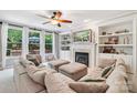 Bright living room with fireplace, built-in bookshelves, and large windows offering natural light at 15620 Glen Miro Dr, Huntersville, NC 28078