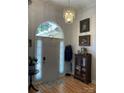 Elegant foyer with hardwood floors, decorative light fixture, and stylish furnishings at 1713 Arbor Way, Albemarle, NC 28001