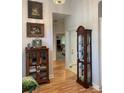 Bright hallway showcasing hardwood floors and beautiful decor, with doorways leading to other rooms at 1713 Arbor Way, Albemarle, NC 28001