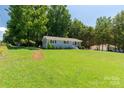 Charming one-story home with light blue brick and a large front yard under a blue sky at 203 Nottingham Dr, York, SC 29745
