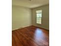 Bright bedroom with hardwood floors and a large window providing ample natural light at 2216 Helen Dr, Gastonia, NC 28054