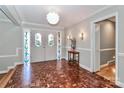Elegant foyer showcasing intricate parquet floors, a decorative entry door, and stylish lighting fixtures at 251 Gleneagles E Rd, Statesville, NC 28625