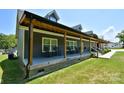 Long covered front porch with rocking chairs, offering a relaxing outdoor space at 265 St Matthews Church Rd, Salisbury, NC 28146