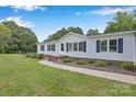 Inviting single-story home featuring a well-manicured lawn and tasteful landscaping at 329 W Red Cross Rd, Oakboro, NC 28129