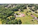 Large lot featuring a metal building with additional structures, encircled by mature trees and greenery at 3724 County Home Rd, Conover, NC 28613