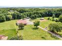 Aerial view of the property showcasing a large metal building, sheds and an American flag at 3724 County Home Rd, Conover, NC 28613