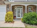 Inviting entrance with a decorative glass door, manicured bushes, and stone accents at 4090 Sunset Dr, Rock Hill, SC 29732