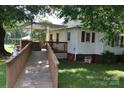 Exterior view featuring a wooden ramp to deck and partially covered patio at 4143 E Maiden Rd, Maiden, NC 28650
