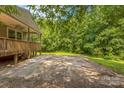 Spacious back patio offering privacy and views of the surrounding wooded landscape at 4699 Cherrystone Rd, Lancaster, SC 29720