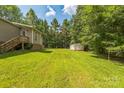 Expansive backyard with lush green grass and storage shed at 4699 Cherrystone Rd, Lancaster, SC 29720