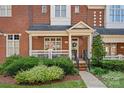 Inviting front porch of a brick townhouse, perfect for relaxing outdoors at 4708 S Hill View Dr, Charlotte, NC 28210