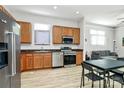 Open-concept kitchen featuring stainless steel appliances and wood cabinets at 474 New Bern Station Ct, Charlotte, NC 28209