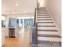 Welcoming entryway features wood floors, staircase and an open view to the living and dining areas at 622 Station St # 48, Clover, SC 29710