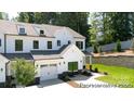 Charming, new construction townhome featuring a white exterior, garage and well-manicured lawn at 622 Station St # 48, Clover, SC 29710