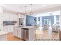 Modern kitchen with stainless steel appliances, center island with pendant lighting, and open dining area at 622 Station St # 48, Clover, SC 29710