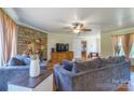 Inviting living room featuring a cozy fireplace, comfortable seating, and hardwood flooring at 6785 Knotty Wood Ln, Vale, NC 28168