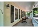 Inviting front porch with rocking chairs, perfect for relaxing and enjoying the outdoors at 9334 New Towne Dr, Matthews, NC 28105