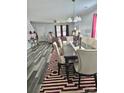Dining room with an elegant table setting, modern chandelier, and decorative rug at 1216 Catawba Run, Lowell, NC 28098