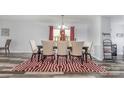 Elegant dining room with seating for six, modern flooring, and natural light at 1216 Catawba Run, Lowell, NC 28098