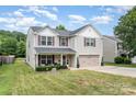 Well-maintained two-story home with a lush green lawn and attached two-car garage at 1216 Catawba Run, Lowell, NC 28098
